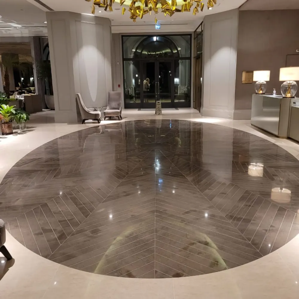 Hall de entrada com piso de mármore em padrão espinha de peixe polido